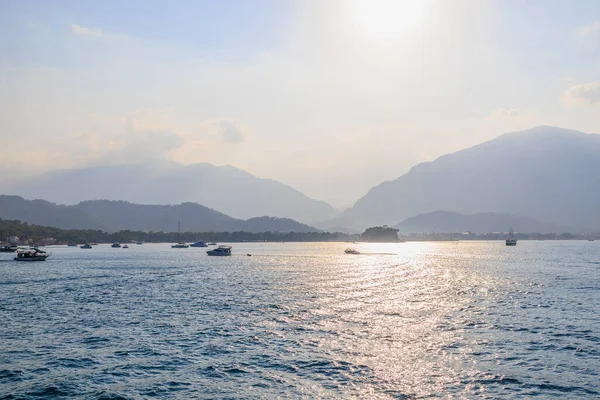 Sea mountain coast of the Mediterranean Sea in the coastal zone of the city and port. Background with copy space. August 9, 2022 Kemer, Antalya province, Turkey.