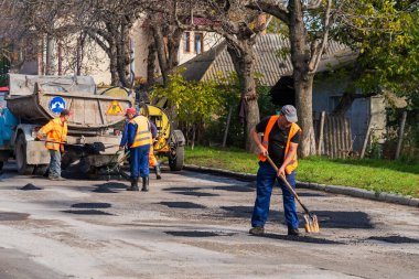 Road workers are repairing the road. Background with selective focus as copy space for text. October 25, 2022 Balti Moldova.