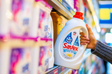 The customer takes liquid laundry detergent from the shelf. Department of cleanliness in the supermarket. October 11, 2022 Beltsy Moldova.