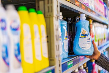 The customer takes the fabric softener from the shelf. Department of cleanliness in the supermarket. October 11, 2022 Beltsy Moldova.
