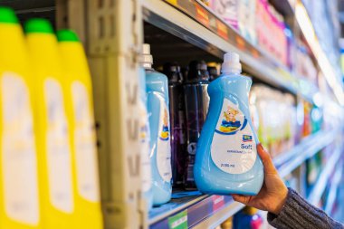 The customer takes the fabric softener from the shelf. Department of cleanliness in the supermarket. October 11, 2022 Beltsy Moldova.