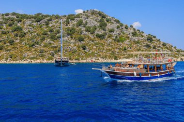 August 10, 2022 Demre, Antalya province, Turkey. Yachts near the Turkish rocky shore. Background with copy space for text