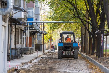 Heavy machinery. Repair of intra-yard or intra-quarter roads, background. November 4, 2022 Beltsy Moldova