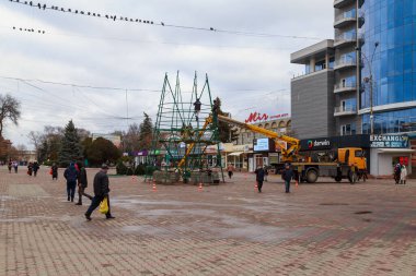 Background of assembling artificial urban Christmas tree in the Christmas town. December 17, 2021 Balti Moldova