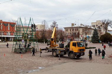 Background of assembling artificial urban Christmas tree in the Christmas town. December 17, 2021 Balti Moldova