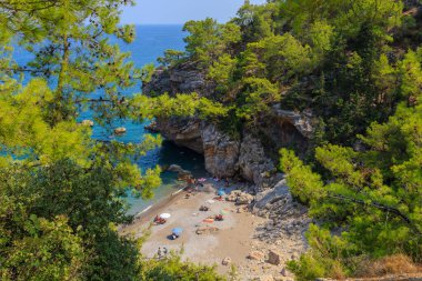Wild Turkish beach in the Bay of the mountain coast of the Mediterranean Sea. August 7, 2022 Beldibi Antalya province, Kemer region Turkey.