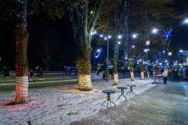 The lights of the night city, decorated with garlands for the Christmas and New Year holidays. December 24, 2021 Balti Moldova.