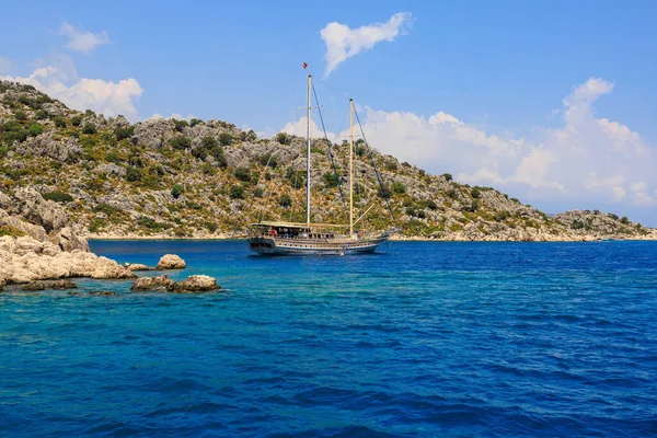 August 10, 2022 Demre, Antalya province, Turkey. Yachts near the Turkish rocky shore. Background with copy space for text