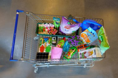 A full shopping cart of a customer in a supermarket with goods for the garden. February 17, 2022 Beltsy Moldova.