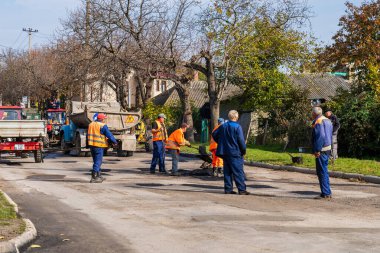 Road workers are repairing the road. Background with selective focus as copy space for text. October 25, 2022 Balti Moldova.