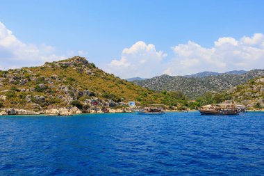 August 10, 2022 Demre, Antalya province, Turkey. Yachts near the Turkish rocky shore. Background with copy space for text