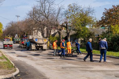 Road workers are repairing the road. Background with selective focus as copy space for text. October 25, 2022 Balti Moldova.