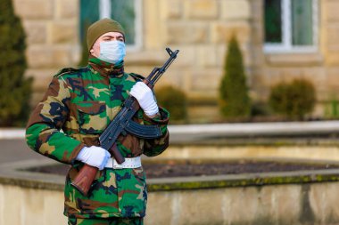 February 12, 2022 Balti Moldova. Soldier of the guard of honor on duty in an urban environment. Background