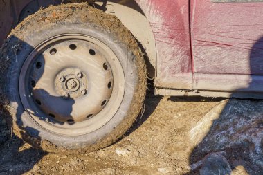 February 14, 2022 Cuhurestii Moldova. Editorial background for news. The wheel of a stuck car.