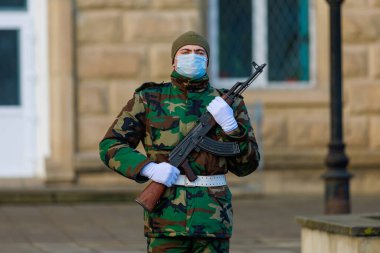 February 12, 2022 Balti Moldova. Soldier of the guard of honor on duty in an urban environment. Background