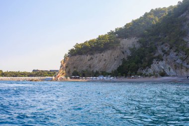 Sea mountain coast of the Mediterranean Sea in the coastal zone of the city and port. Background with copy space. August 9, 2022 Kemer, Antalya province, Turkey.
