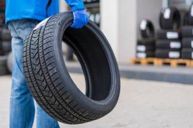 November 2, 2022 Balti Moldova. Tire in the worker's hand. Focus on the tire. Illustrative editorial, background