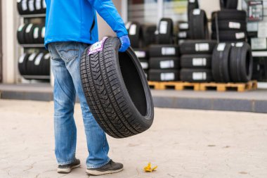 November 2, 2022 Balti Moldova. Tire in the worker's hand. Focus on the tire. Illustrative editorial, background