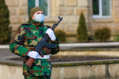 February 12, 2022 Balti Moldova. Soldier of the guard of honor on duty in an urban environment. Background
