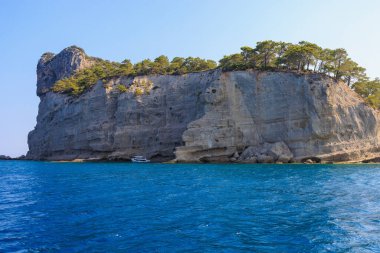Sea mountain coast of the Mediterranean Sea in the coastal zone of the city and port. Background with copy space. August 9, 2022 Kemer, Antalya province, Turkey.