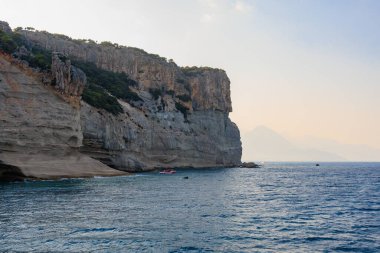 Sea mountain coast of the Mediterranean Sea in the coastal zone of the city and port. Background with copy space. August 9, 2022 Kemer, Antalya province, Turkey.