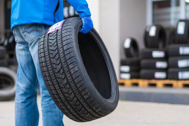 November 2, 2022 Balti Moldova. Tire in the worker's hand. Focus on the tire. Illustrative editorial, background