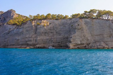 Sea mountain coast of the Mediterranean Sea in the coastal zone of the city and port. Background with copy space. August 9, 2022 Kemer, Antalya province, Turkey.