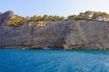Sea mountain coast of the Mediterranean Sea in the coastal zone of the city and port. Background with copy space. August 9, 2022 Kemer, Antalya province, Turkey.