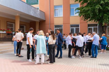 14 Haziran 2022 Balti Moldova. Öğrenciler sınavlardan sonra sonuçları bekliyorlar. Resimli editör arkaplanı