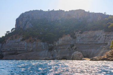 Sea mountain coast of the Mediterranean Sea in the coastal zone of the city and port. Background with copy space. August 9, 2022 Kemer, Antalya province, Turkey.