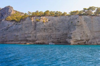Sea mountain coast of the Mediterranean Sea in the coastal zone of the city and port. Background with copy space. August 9, 2022 Kemer, Antalya province, Turkey.
