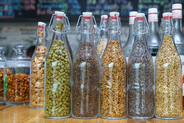 stock image May 4, 2022 Beltsy, Moldova. Decorative glass bottles with ingredients for brewing beer in a beer store. Illustrative editorial.