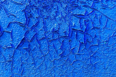 Kabarık desenli duvar yüzeyinde çatlak boya var. Tasarım için arkaplan, grafik kaynak. Grunge..