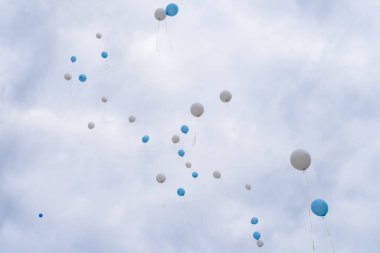 Balloons released into the sky on a holiday.