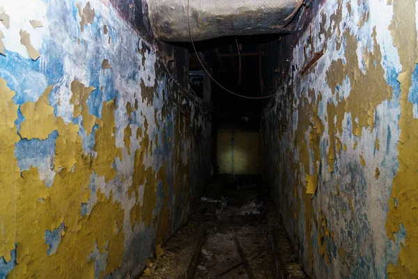 Corridor of a destroyed and abandoned secret military bunker. Background with selective focus