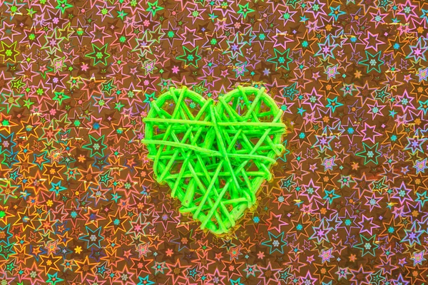 Wooden wicker heart. Rattan work in the shape of a heart. Love concept. Background with selective focus and copy space. Holographic back