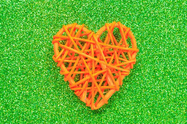 Wooden wicker heart. Rattan work in the shape of a heart. Love concept. Background with selective focus and copy space. Glitter back