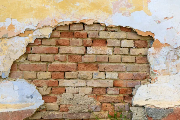 Old brick wall and crumbling plaster. Background or backdrop. Blank for design, graphic resource