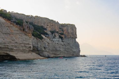 Sea mountain coast of the Mediterranean Sea in the coastal zone of the city and port. Background with copy space. August 9, 2022 Kemer, Antalya province, Turkey.