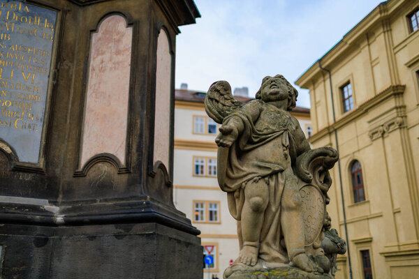 August 23, 2022 Prague, Czech Republic. Ancient sculpture in urban architecture. Background with selective focus and copy space