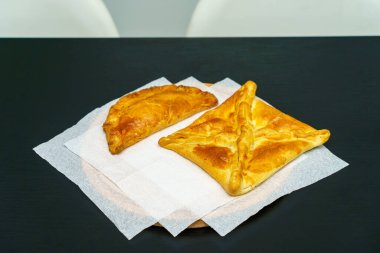 Khachapuri ve börekler. İştah açıcı hamur işleri. Fast food. Fırından atıştırmalık bir şeyler. Seçici odak ve kopyalama alanı olan arkaplan