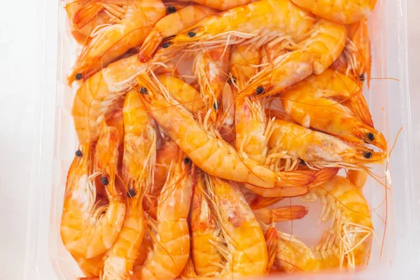 Shrimp on ice in a store fridge, background with selective focus.