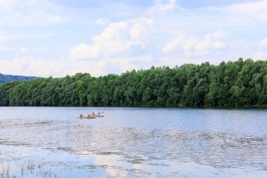 İnsanlar bir kanoyla nehir boyunca seyahat ederler. Rafting sağlıklı bir yaşam tarzı. Kopyalama alanı olan arkaplan
