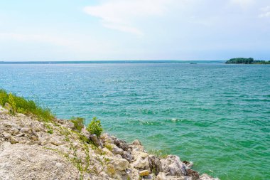 Taze bir rezervuarın kayalık kıyısı. Seçici odaklı arkaplan ve metin için alanı kopyala.