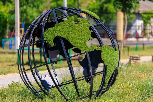 Green planet globe. Background with selective focus and copy space for text.