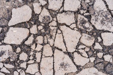 Yolda çukurlar var ve asfalt parçalanmış. Metin için kopyalama alanı olan arkaplan