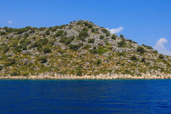 stock image View of the rocky shore from the sea. Background with selective focus and copy space for text. Mediterranean Sea in Turkey. Popular tourist places