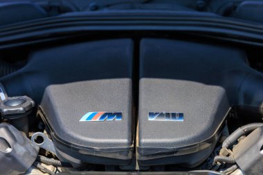 A detailed close-up of the BMW M5 F10 V10 engine bay, highlighting the iconic M series badge and exceptional performance engineering. July 2, 2023. Liadoveni, Moldova. clipart