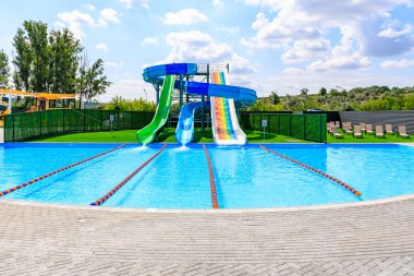 Kaydırak ve su parkı olan bir havuz. Havuz bir çitle çevrili ve bir kaydırak ve bir su parkı var. 8 Haziran 2024 Balti Moldova
