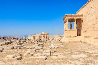 A view of a building with a balcony and a statue. The building is old and has a lot of history. The view is of a city with a lot of buildings. August 9, 2024 Athens Greece clipart